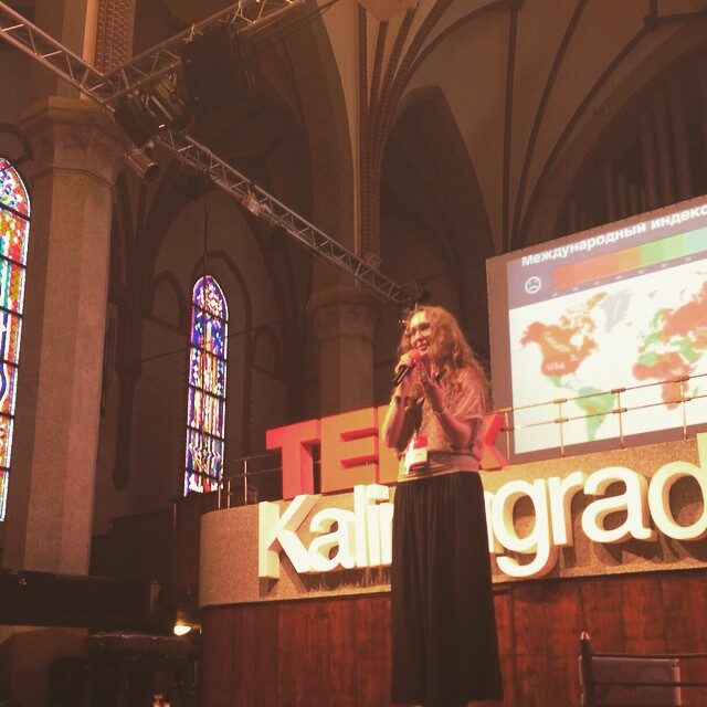 Victoria Puzach speaking on stage at a conference.