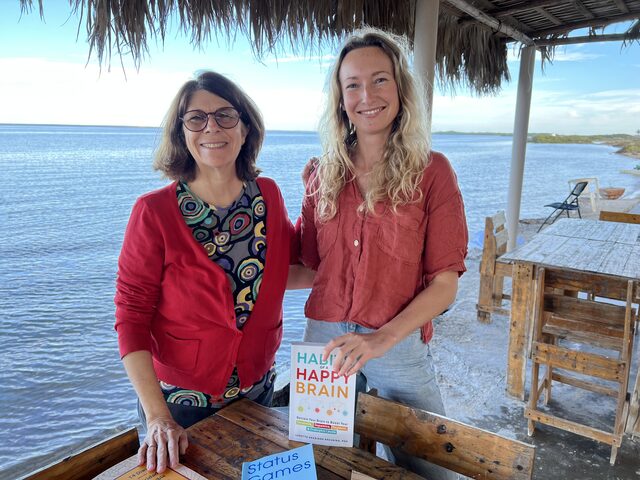 Victoria Puzach with an author client, who is holding her book.
